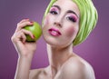 Fashion modell with beautiful pink makeup and green apple Royalty Free Stock Photo