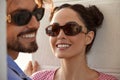 Fashion models couple wearing sunglasses. Sexy woman and handsome young man portrait over light background. Attractive Royalty Free Stock Photo