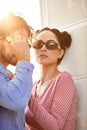 Fashion models couple wearing sunglasses. Sexy woman and handsome young man portrait over light background. Attractive Royalty Free Stock Photo