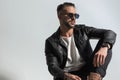 Fashion modern man in leather jacket with sunglasses looking to side Royalty Free Stock Photo