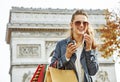 Fashion-monger near Arc de Triomphe having coffee and macaroon Royalty Free Stock Photo