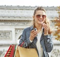 Fashion-monger near Arc de Triomphe having coffee and macaroon Royalty Free Stock Photo