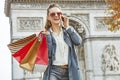 Fashion-monger near Arc de Triomphe using mobile phone, Paris Royalty Free Stock Photo