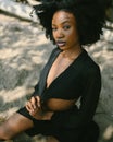 Fashion outdoor beach portrait Beautiful young African American Black woman posing outside on sandy coast with big green Royalty Free Stock Photo