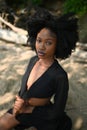 Fashion outdoor beach portrait Beautiful young African American Black woman posing outside on sandy coast with big green Royalty Free Stock Photo