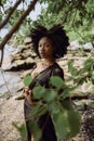 Fashion outdoor beach portrait Beautiful young African American Black woman posing outside on sandy coast with big green Royalty Free Stock Photo