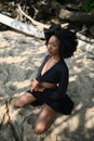 Fashion outdoor beach portrait Beautiful young African American Black woman posing outside on sandy coast with big green Royalty Free Stock Photo