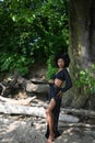 Fashion outdoor beach portrait Beautiful young African American Black woman posing outside on sandy coast with big green Royalty Free Stock Photo