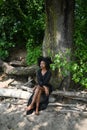 Fashion outdoor beach portrait Beautiful young African American Black woman posing outside on sandy coast with big green Royalty Free Stock Photo