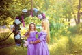 Fashion outdoor photo of beautiful family look. beautiful mother with long dark hair posing with her little cute baby in Royalty Free Stock Photo