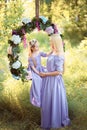 Fashion outdoor photo of beautiful family look. beautiful mother with long dark hair posing with her little cute baby in Royalty Free Stock Photo