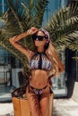 Beautiful sexy woman with blond hair in bikini posing in summer beach club Royalty Free Stock Photo