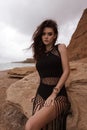 beautiful woman with dark hair in casual clothes posing in desert of Cyprus