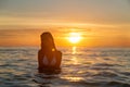 Fashion outdoor photo of sexy beautiful girl with blonde hair in elegant white bikini relaxing on the sea Royalty Free Stock Photo