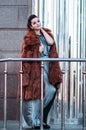 Fashion outdoor photo of glamour woman with dark hair wearing luxurious fur coat and leather gloves,posing Royalty Free Stock Photo