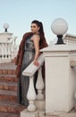Fashion outdoor photo of glamour woman with dark hair wearing luxurious fur coat and leather gloves Royalty Free Stock Photo