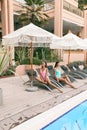 Women in elegant swimming suit relaxing near swimming pool Royalty Free Stock Photo