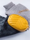 Fashion outfit with gray turtle neck, yellow bag Royalty Free Stock Photo