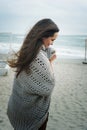 Fashion pensive woman portrait walking alone on a sea beach