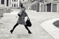 Fashion and people concept - happy young woman or teenage girl running and jumping high on city street Royalty Free Stock Photo