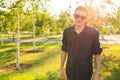 Fashion, people and lifestyle concept - Close-up portrait of happy cheerful confident handsome man in sunglasses in park Royalty Free Stock Photo