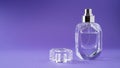 Fashion perfume in glass bottle on purple background. Diamond bottle shape. Transparent bottle. Crystal. Isolated Royalty Free Stock Photo