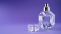 Fashion perfume in glass bottle on purple background. Diamond bottle shape. Transparent bottle. Crystal. Isolated Royalty Free Stock Photo
