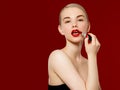 Fashion photo. Closeup of woman face with bright red matte lipstick on full lips. Beauty Cosmetics, Makeup Concept. A Royalty Free Stock Photo