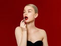 Fashion photo. Closeup of woman face with bright red matte lipstick on full lips. Beauty Cosmetics, Makeup Concept. A Royalty Free Stock Photo