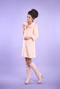 Fashion photo of fashionable lady in pink coat with elegant hair Royalty Free Stock Photo