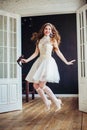 Fashion photo of happy jumping girl wearing wedding dress