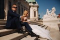 Fashion photo of wedding couple. Groom wears blue suit and tie bow. Bride wears white wedding dress Royalty Free Stock Photo