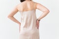 Fashion photo of young lady in elegant evening dress on white background, close-up back view. Royalty Free Stock Photo