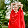 Fashion photo of young magnificent woman in red dress. Outdoor p