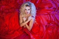 Fashion photo of young magnificent woman in red dress. Studio portrait Royalty Free Stock Photo