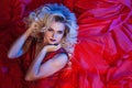 Fashion photo of young magnificent woman in red dress. Studio portrait Royalty Free Stock Photo