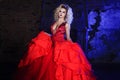 Fashion photo of young magnificent woman. Running towards camera. Seductive blonde in red dress with fluffy skirt Royalty Free Stock Photo