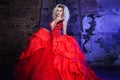 Fashion photo of young magnificent woman. Running towards camera. Seductive blonde in red dress with fluffy skirt Royalty Free Stock Photo