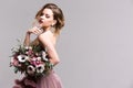 Fashion photo of young woman. Woman posing in pink dress. Studio.