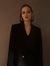 Fashion photography. A beautiful girl in a black jacket with a dramatic light. Imitation grain film Royalty Free Stock Photo
