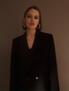 Fashion photography. A beautiful girl in a black jacket with a dramatic light. Imitation grain film Royalty Free Stock Photo