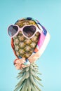 Fashion. Pineapple hipster in sunglasses and scarf, stylish fruit. Minimal summer tropical concept. Creative art fashionable Royalty Free Stock Photo