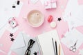 Fashion pink woman workplace background. Coffee, macaron, office supply, gift and clean notebook on pastel desk top view.