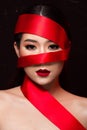 Asian caucasian woman with strong color red lips