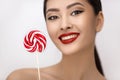 Fashion Portrait of Asian Woman with Lollipop in Studio Royalty Free Stock Photo