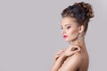 Fashion portrait of a beautiful attractive girl with a gentle elegant evening wedding hairstyles high and bright make-up