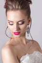 Fashion portrait of a beautiful attractive girl with a gentle elegant evening wedding hairstyles high and bright make-up with flow Royalty Free Stock Photo