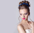 Fashion portrait of a beautiful attractive girl with a gentle elegant evening wedding hairstyles high and bright make-up with flow Royalty Free Stock Photo