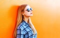 Fashion portrait beautiful blonde woman on a colorful orange background Royalty Free Stock Photo