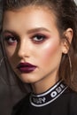Fashion portrait of a beautiful girl with professional makeup, lilac eyeshadows, rich lashes, marsala lips. Pop style